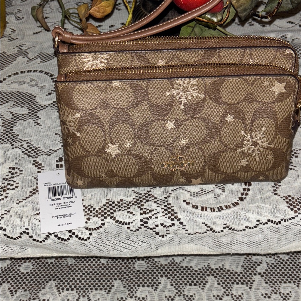 Coach Double Zip Wallet in Signature Canvas with a Star and Snowflake print.